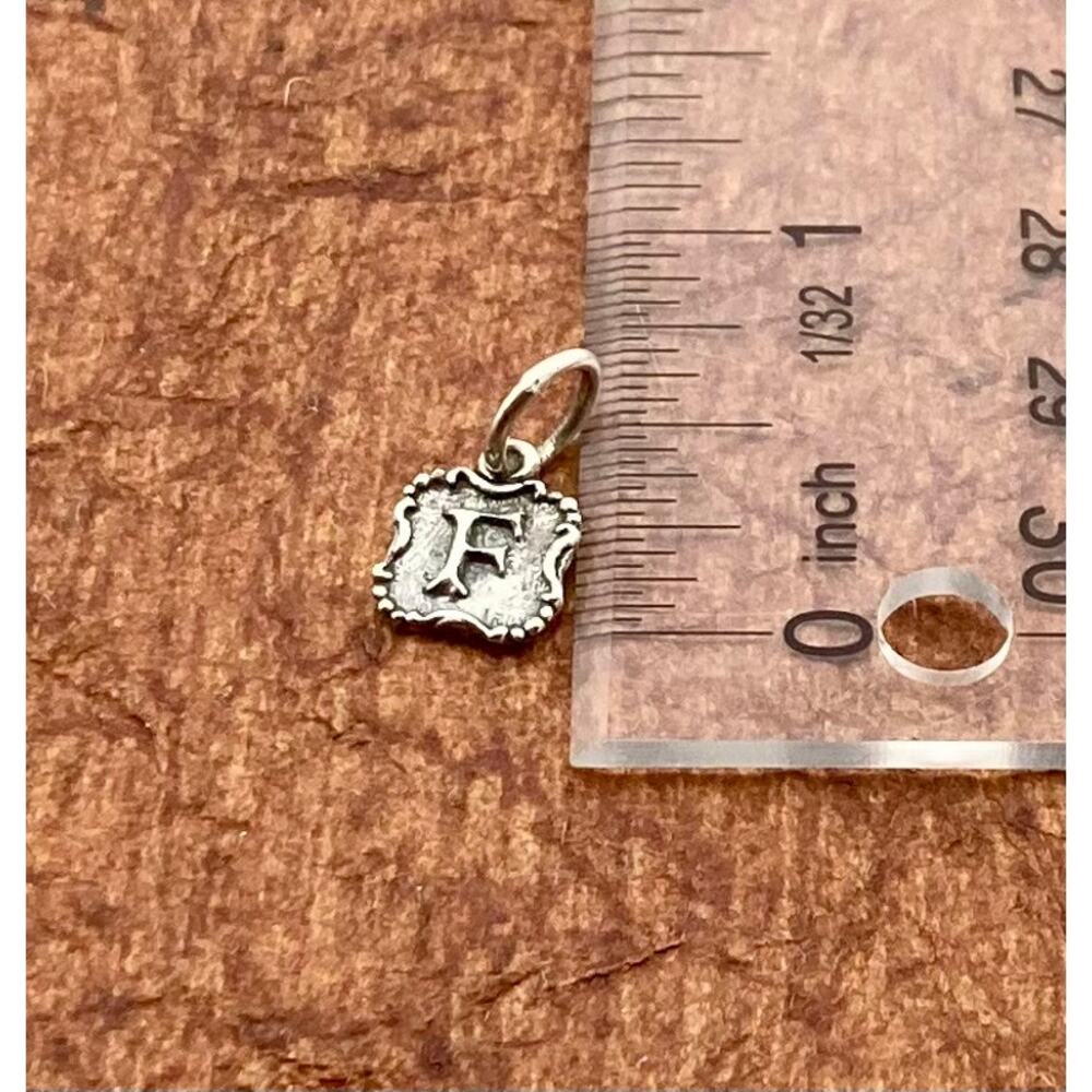 Waxing poetic insignia initial charm